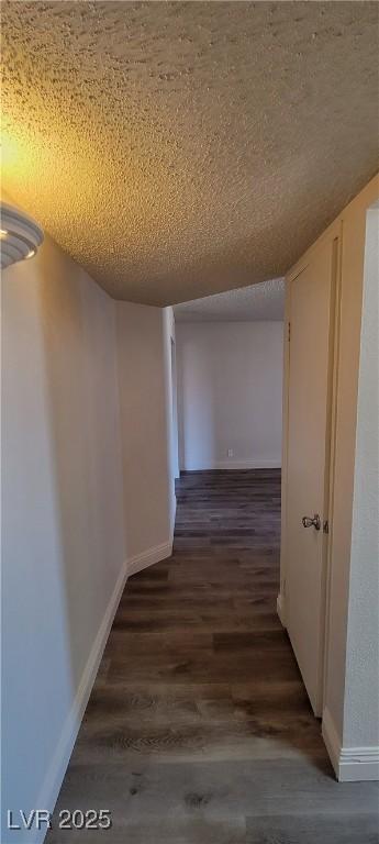 3151 Soaring Gulls Dr Unit 2058, Las Vegas, NV 89128 - hallway featuring dark wood-type flooring, a textured ceiling, and baseboards