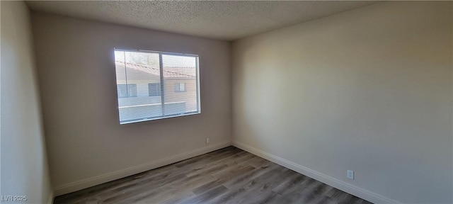 3151 Soaring Gulls Dr Unit 2058, Las Vegas, NV 89128 - empty room with wood finished floors, a textured ceiling, and baseboards