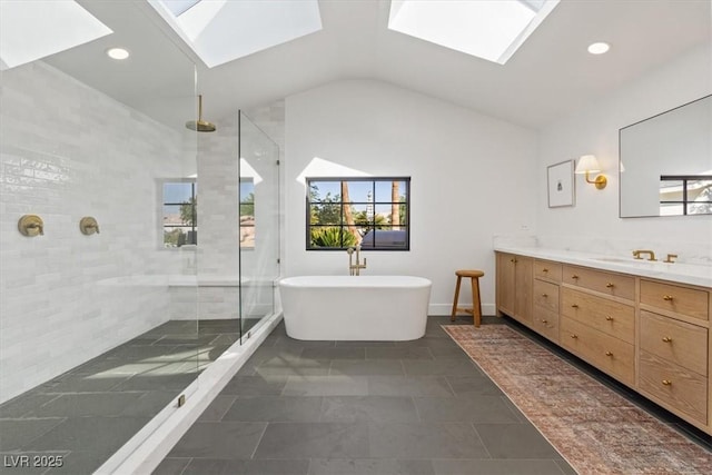 204 Canyon Dr, Las Vegas, NV 89107 - bathroom featuring a skylight, vanity, tiled shower, vaulted ceiling, and a freestanding bath