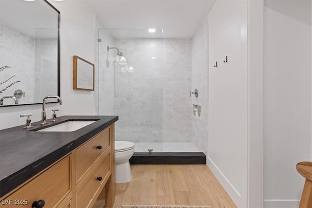 204 Canyon Dr, Las Vegas, NV 89107 - bathroom featuring toilet, vanity, wood finished floors, a tile shower, and recessed lighting