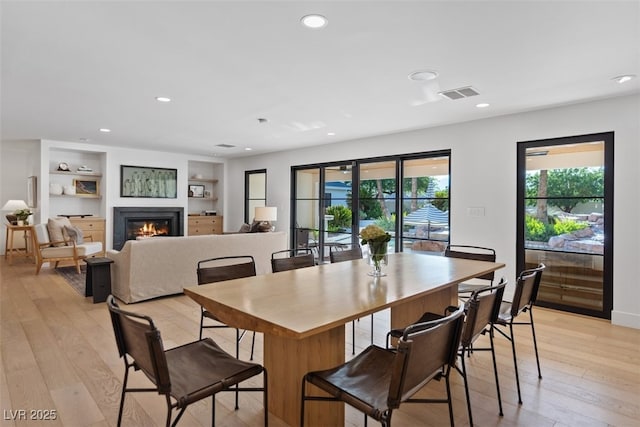 204 Canyon Dr, Las Vegas, NV 89107 - dining space with a glass covered fireplace, light wood finished floors, and recessed lighting