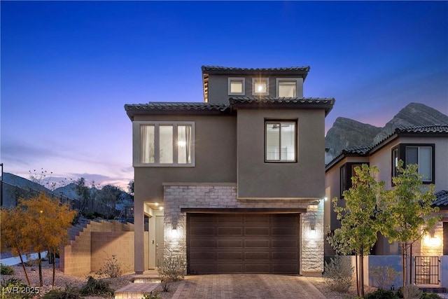 2367 Ridgeline Wash St, Las Vegas, NV 89138 - mediterranean / spanish-style home with stucco siding, a tile roof, stone siding, and decorative driveway