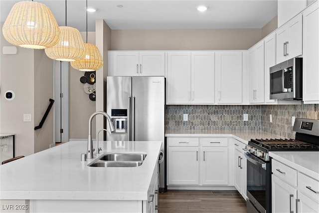 2367 Ridgeline Wash St, Las Vegas, NV 89138 - kitchen featuring appliances with stainless steel finishes, a sink, light countertops, dark wood-style floors, and backsplash