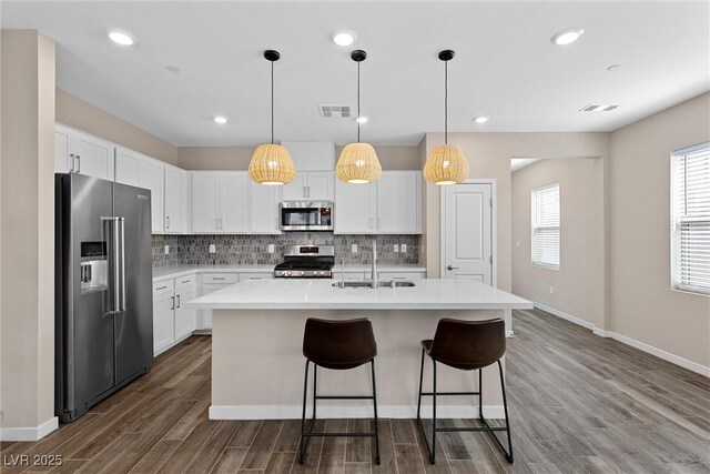 2367 Ridgeline Wash St, Las Vegas, NV 89138 - kitchen featuring appliances with stainless steel finishes, a sink, decorative backsplash, light countertops, and dark wood-type flooring