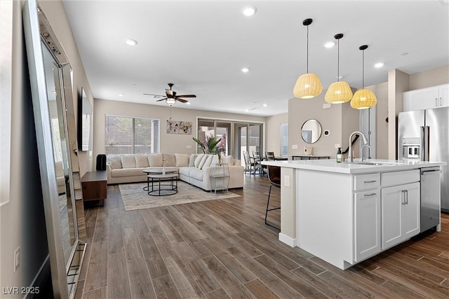 2367 Ridgeline Wash St, Las Vegas, NV 89138 - kitchen with a sink, open floor plan, a ceiling fan, white cabinets, and dark wood-type flooring