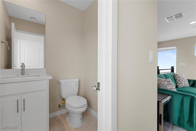 2367 Ridgeline Wash St, Las Vegas, NV 89138 - bathroom with toilet, vanity, baseboards, tile patterned flooring, and connected bathroom