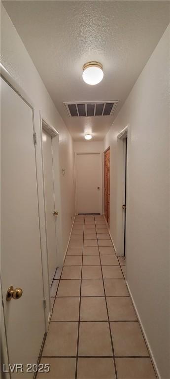 2216 Short Pine Dr, Las Vegas, NV 89108 - hallway featuring light tile patterned flooring and a textured ceiling