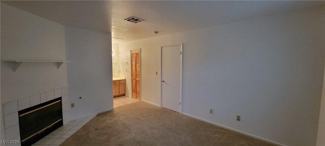 2216 Short Pine Dr, Las Vegas, NV 89108 - unfurnished living room with light colored carpet and a tiled fireplace
