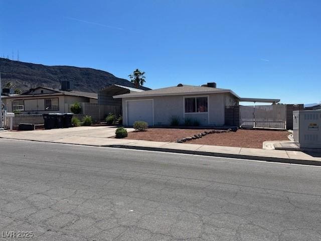 460 Crestway Rd, Henderson, NV 89015 - view of front facade featuring concrete driveway, an attached garage, and a mountain view