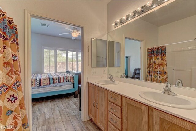 2304 Willow Wren Dr, North Las Vegas, NV 89084 - bathroom with ensuite bathroom, a ceiling fan, double vanity, wood finished floors, and curtained shower
