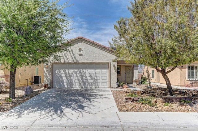 2304 Willow Wren Dr, North Las Vegas, NV 89084 - view of front facade featuring stucco siding, driveway, a garage, and central AC