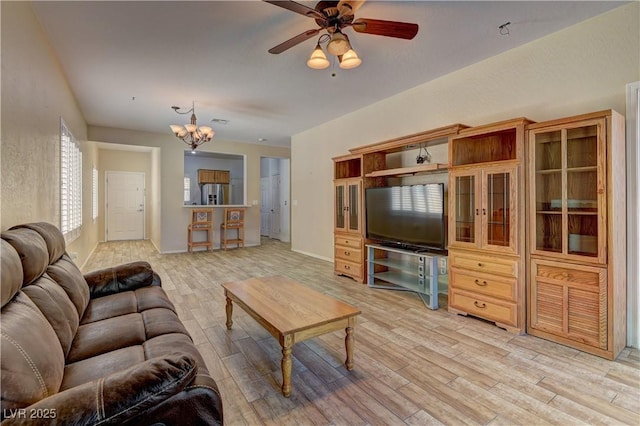 2304 Willow Wren Dr, North Las Vegas, NV 89084 - living room featuring light wood-style flooring, ceiling fan, and a chandelier