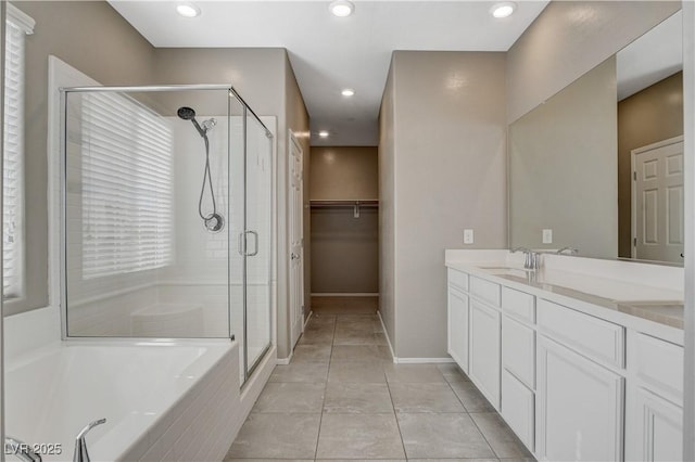 8486 Insignia Ave Unit 101, Las Vegas, NV 89178 - full bath with a stall shower, double vanity, tile patterned floors, a garden tub, and baseboards