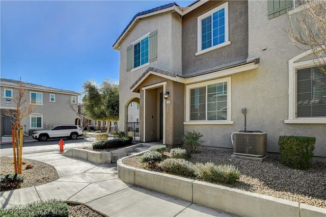 8486 Insignia Ave Unit 101, Las Vegas, NV 89178 - view of front facade with stucco siding and central air condition unit