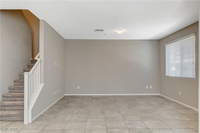 8486 Insignia Ave Unit 101, Las Vegas, NV 89178 - unfurnished room with stairway, light tile patterned floors, and baseboards