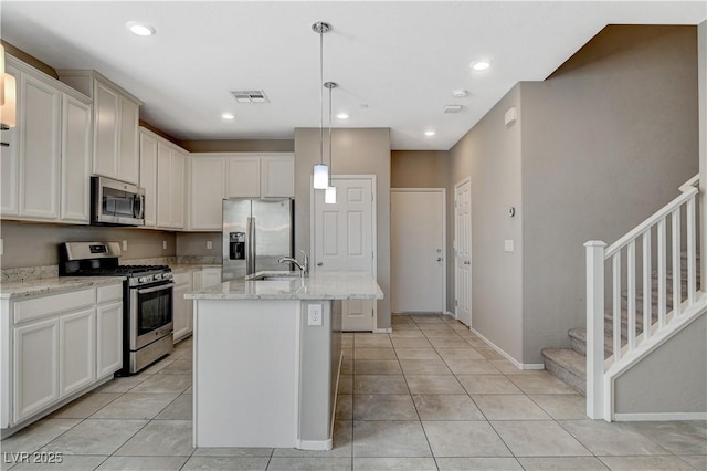 8486 Insignia Ave Unit 101, Las Vegas, NV 89178 - kitchen with appliances with stainless steel finishes, light tile patterned floors, a sink, an island with sink, and recessed lighting