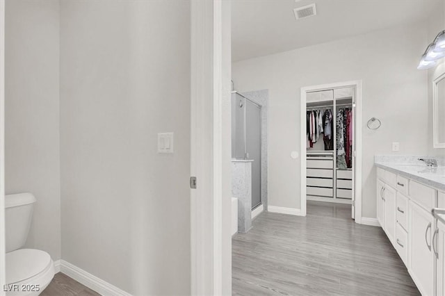 11856 Barona Mesa Ave, Las Vegas, NV 89138 - full bath with a spacious closet, vanity, a shower stall, and wood finished floors