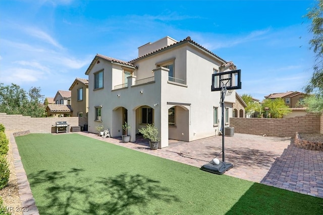 11856 Barona Mesa Ave, Las Vegas, NV 89138 - back of house with a balcony, stucco siding, a fenced backyard, and a patio area