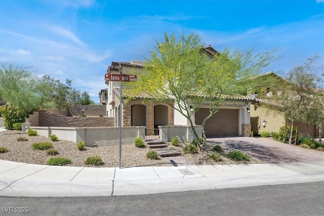 11856 Barona Mesa Ave, Las Vegas, NV 89138 - mediterranean / spanish-style house with a garage, stone siding, driveway, stucco siding, and a tiled roof