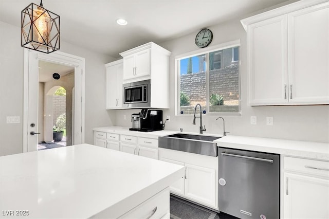 11856 Barona Mesa Ave, Las Vegas, NV 89138 - kitchen featuring stainless steel appliances, light countertops, white cabinetry, hanging light fixtures, and recessed lighting