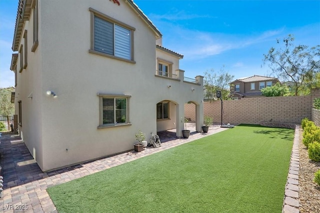 11856 Barona Mesa Ave, Las Vegas, NV 89138 - rear view of house with stucco siding, a fenced backyard, a patio area, and a balcony