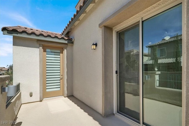 11856 Barona Mesa Ave, Las Vegas, NV 89138 - entrance to property with a tiled roof, stucco siding, and a balcony
