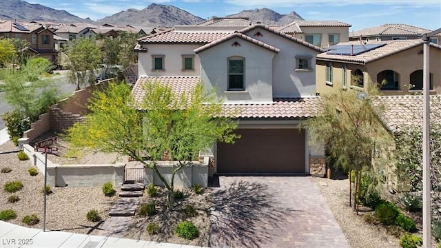 11856 Barona Mesa Ave, Las Vegas, NV 89138 - mediterranean / spanish-style house featuring stucco siding, a tiled roof, decorative driveway, and an attached garage