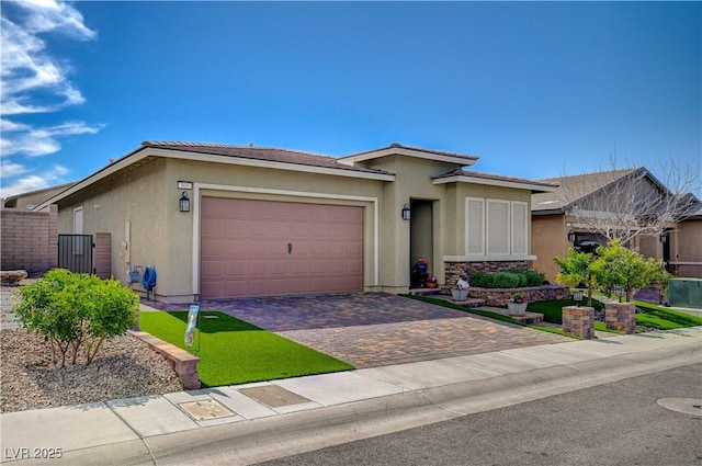 505 Sterling Falls Ave, Henderson, NV 89011 - ranch-style house with an attached garage, decorative driveway, stucco siding, and a tiled roof