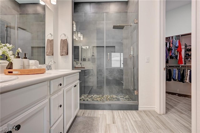 505 Sterling Falls Ave, Henderson, NV 89011 - full bath featuring vanity, a stall shower, a spacious closet, and wood finished floors