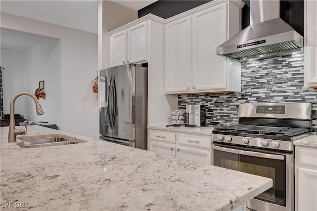 505 Sterling Falls Ave, Henderson, NV 89011 - kitchen with appliances with stainless steel finishes, wall chimney range hood, a sink, and white cabinetry
