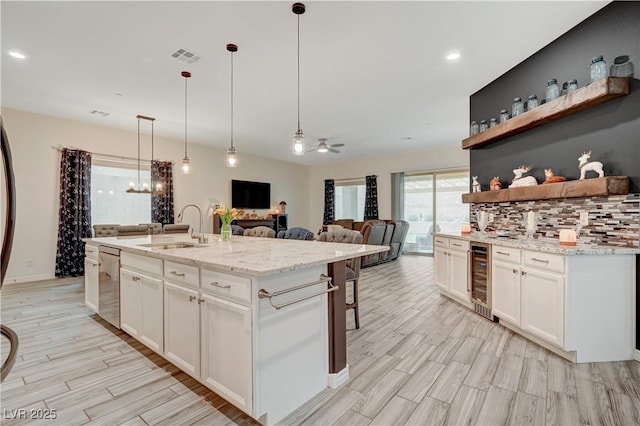 505 Sterling Falls Ave, Henderson, NV 89011 - kitchen with dishwasher, a sink, beverage cooler, light wood finished floors, and open shelves