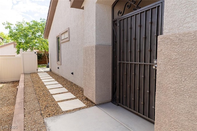 2021 Pelican Sky Beach Ave, North Las Vegas, NV 89081 - view of exterior entry featuring stucco siding and a gate