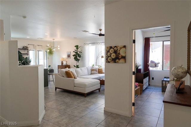 2021 Pelican Sky Beach Ave, North Las Vegas, NV 89081 - living area featuring light tile patterned flooring, a chandelier, and baseboards