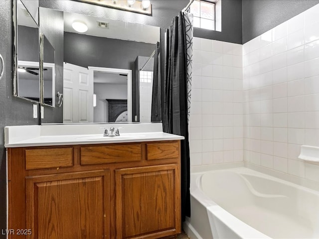 3040 Balcones Fault Ave, North Las Vegas, NV 89081 - ensuite bathroom featuring shower / bath combo with shower curtain, vanity, and a textured wall