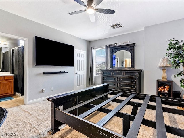 3040 Balcones Fault Ave, North Las Vegas, NV 89081 - bedroom with ensuite bathroom, light colored carpet, baseboards, and ceiling fan