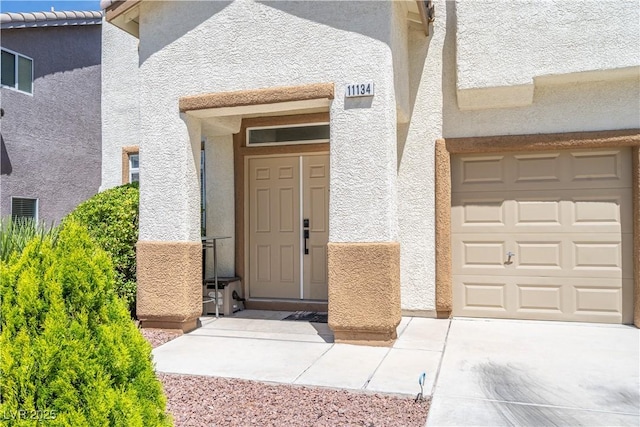11134 Casala Ct, Las Vegas, NV 89141 - view of exterior entry featuring stucco siding and an attached garage