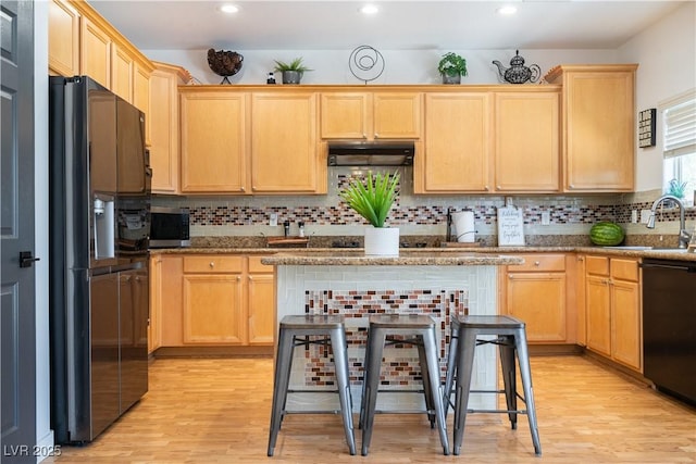 11134 Casala Ct, Las Vegas, NV 89141 - kitchen with black appliances, a sink, under cabinet range hood, light brown cabinets, and light wood-type flooring