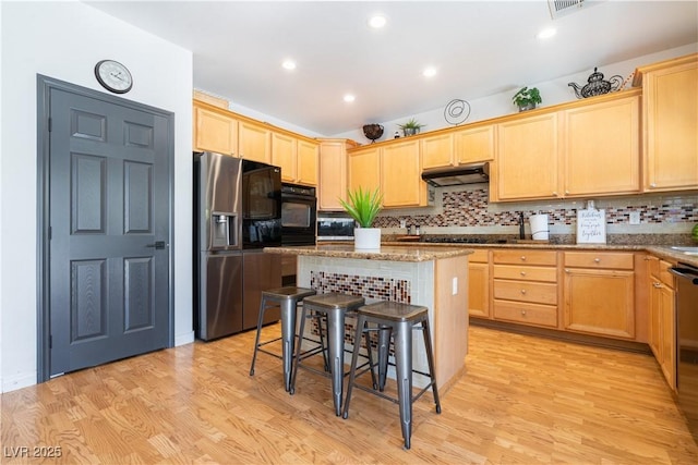 11134 Casala Ct, Las Vegas, NV 89141 - kitchen featuring stainless steel fridge with ice dispenser, oven, light brown cabinetry, under cabinet range hood, and light wood-type flooring
