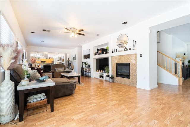 11134 Casala Ct, Las Vegas, NV 89141 - living area featuring ceiling fan, wood finished floors, stairway, and a tiled fireplace