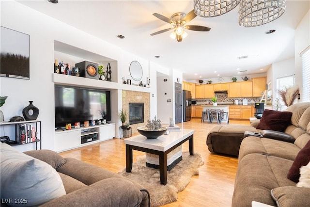 11134 Casala Ct, Las Vegas, NV 89141 - living room featuring a ceiling fan, light wood finished floors, a fireplace, and recessed lighting