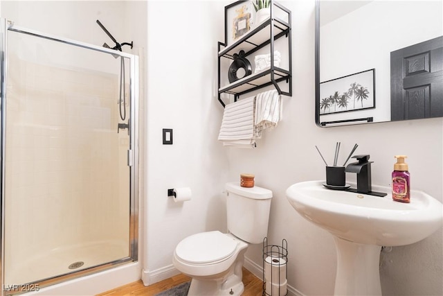 11134 Casala Ct, Las Vegas, NV 89141 - full bathroom featuring a shower stall, toilet, wood finished floors, and baseboards