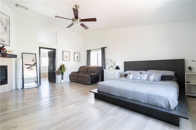 11134 Casala Ct, Las Vegas, NV 89141 - bedroom featuring a fireplace, wood finished floors, and a ceiling fan