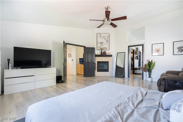 11134 Casala Ct, Las Vegas, NV 89141 - bedroom with a tiled fireplace, wood finished floors, and a ceiling fan