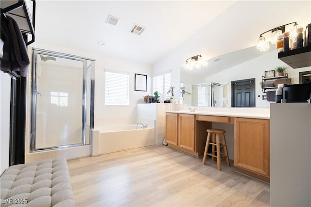 11134 Casala Ct, Las Vegas, NV 89141 - full bathroom featuring a bath, lofted ceiling, a shower stall, vanity, and wood finished floors