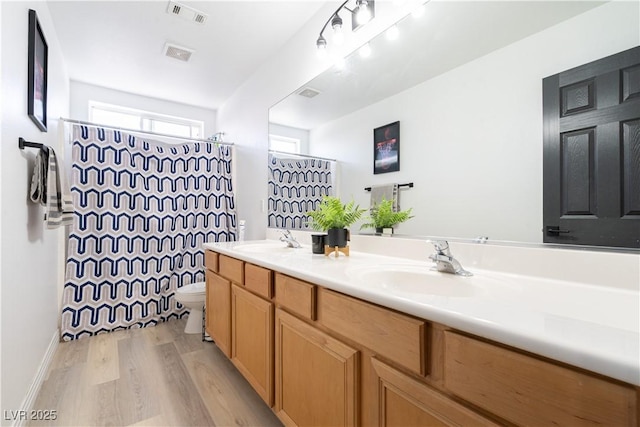 11134 Casala Ct, Las Vegas, NV 89141 - full bathroom with toilet, double vanity, wood finished floors, and curtained shower