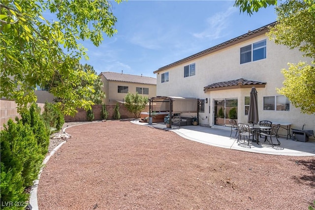11134 Casala Ct, Las Vegas, NV 89141 - back of property with a covered hot tub, a patio area, a fenced backyard, stucco siding, and a tiled roof