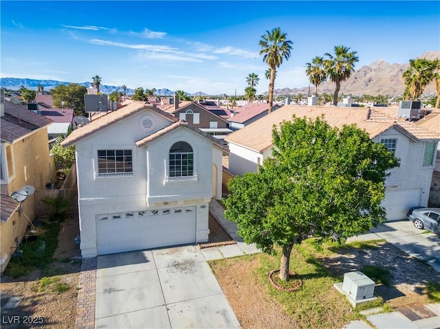 5984 Emerald Canyon Dr, Las Vegas, NV 89142 - view of front of property featuring a garage, driveway, a mountain view, stucco siding, and a residential view