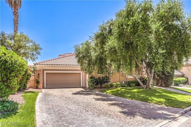 27 Via Paradiso St, Henderson, NV 89011 - view of front facade featuring stucco siding, an attached garage, decorative driveway, a front lawn, and a tile roof