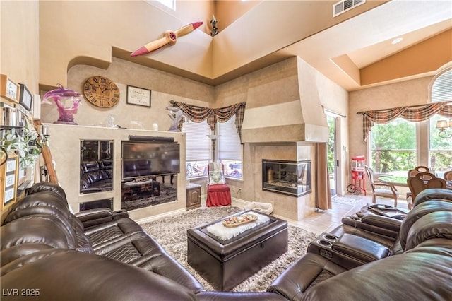 27 Via Paradiso St, Henderson, NV 89011 - living area featuring a fireplace, a towering ceiling, and tile patterned flooring