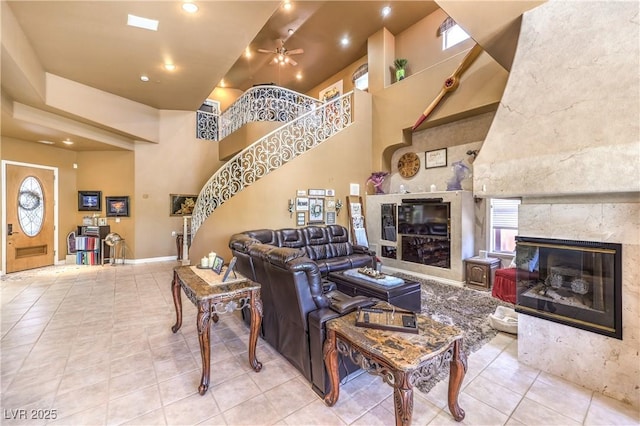 27 Via Paradiso St, Henderson, NV 89011 - tiled living area featuring a fireplace, stairs, a ceiling fan, a high ceiling, and recessed lighting